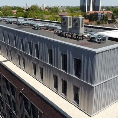 Vue aérienne de la résidence Le Cid à Roubaix montrant les façades en bardage métallique et la toiture terrasse équipée de systèmes techniques, travaux d’enveloppe réalisés par Applitech Enveloppe.